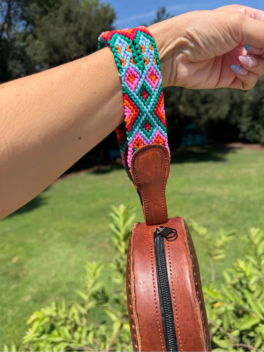 Hand-Tooled Round Leather Wristlet Bag with Colorful Woven Strap